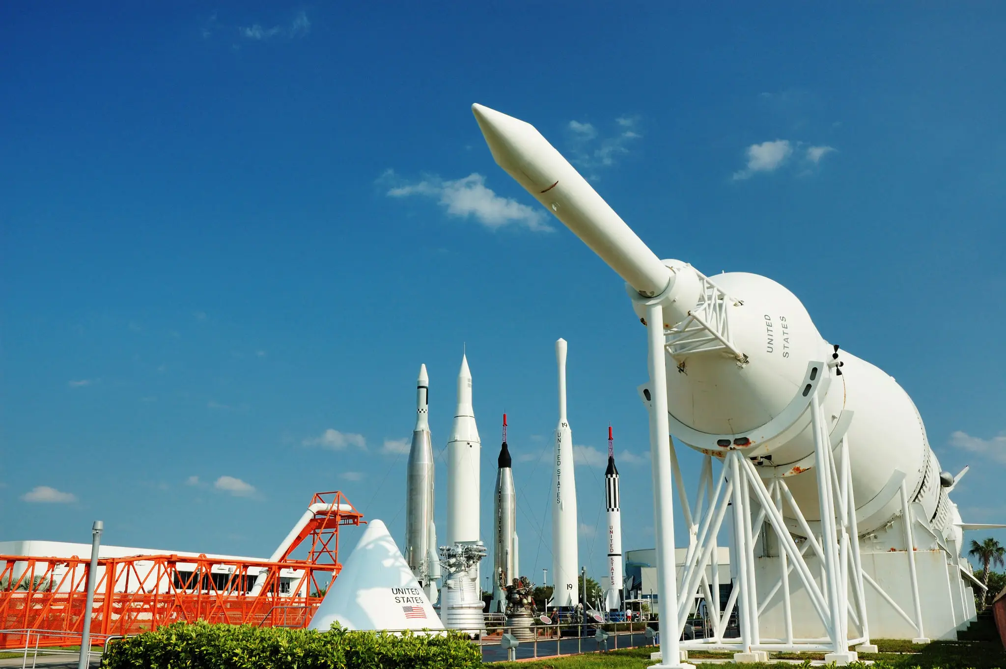 Outdoor exhibit of rockets under clear blue sky